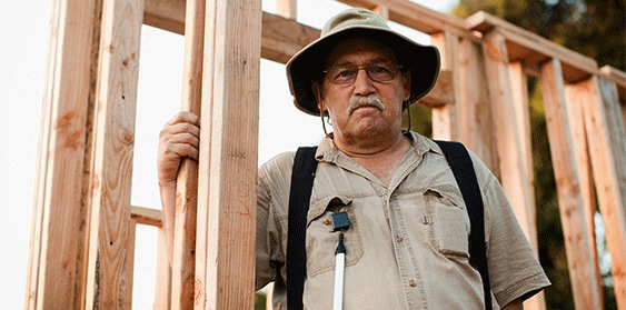 Older man standing in construction site