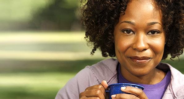woman outside holding a coffee cup