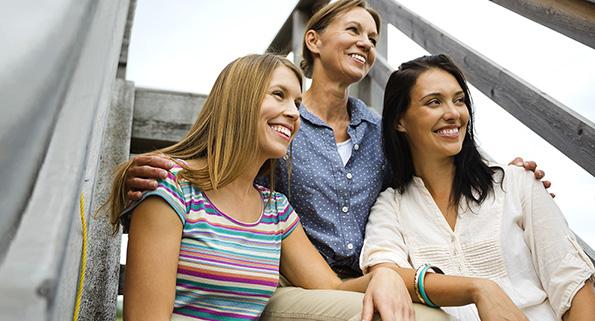 three women sitting on steps