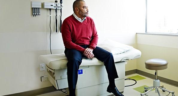 man sitting on a doctor's examination table