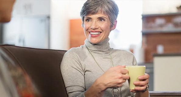 older woman holding a mug